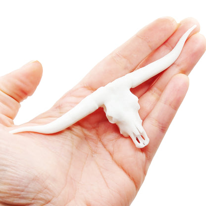 Texas Longhorn skull replica, 1:12 scale, white unpainted finish, held in hand for scale